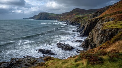 Obraz premium Bradda Head Coastal Cliffs Over Port Erin with Distant Calf of Man