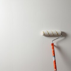 Freshly applied white interior finish covering a wall surface with a paint roller nearby, symbolizing home renovation and DIY projects ,surface ,color ,coating
