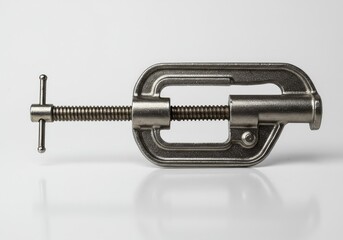 Heavy duty metal G-clamp photographed against a sterile white background, highlighting its thread and jaw mechanism for securing workpieces ,white background ,fixation ,metallic