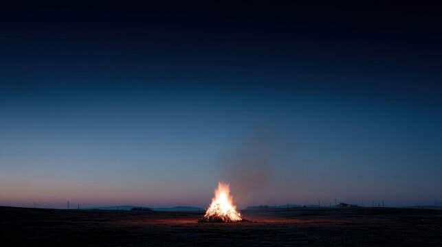 Evening bonfire on open field against twilight sky. Guy Fawkes Night