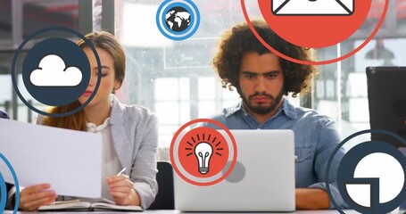Animation of icon in circles over diverse coworkers analyzing reports in meeting at office - Powered by Adobe
