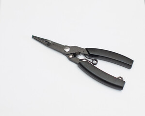 A black pair of scissors for tying hooks is placed on a white background.