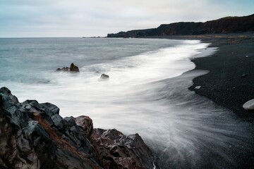 view of the Djupalonssandur black sand and pebble beach on the Snaefellsnes Peninsula