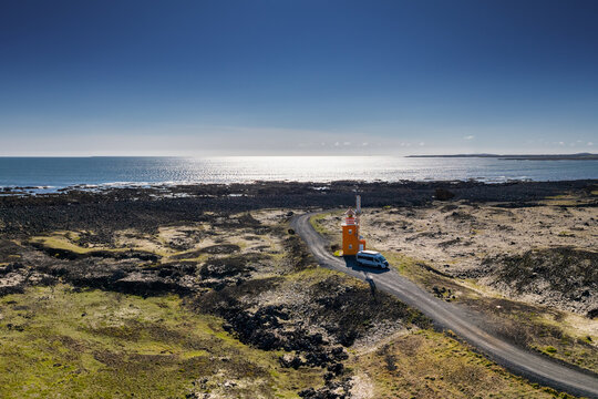 camper van parked next to the lighthouse on the Hopsnes Peninsula in southwestern Iceland near Grindavik