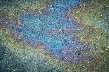 Oil on Pavement Creates Colorful Patterns After Rain in a City Street During the Afternoon