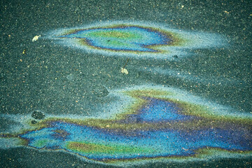 Oil Spill on Pavement With Colorful Patterns During Daylight in an Urban Area