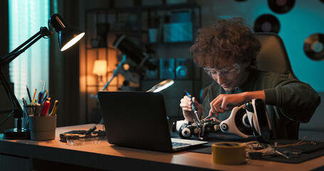 A young learner spends time at a desk, following instructional videos. With full attention, the...
