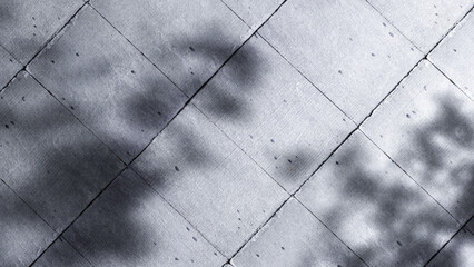Abstract geometric pattern of concrete tiles with soft shadows and sun lights.