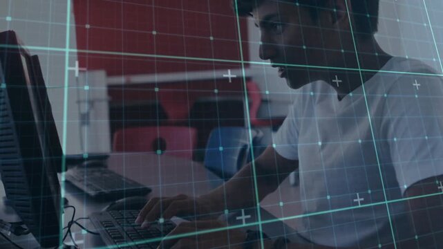 Teenage boy reacting to code prompt, typing and clicking mouse, grid overlay illustrating hacking