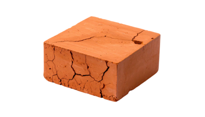 Single, weathered, reddish-brown brick isolated on a black background