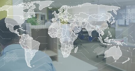 Office professional typing at keyboard and initiating world map overlay for global data monitoring - Powered by Adobe