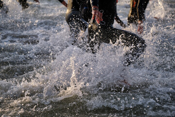 People participating in a water sports event on a sunny day near the ocean
