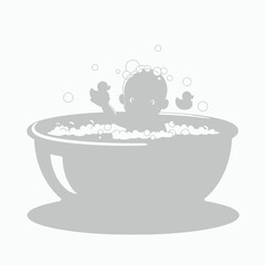 Baby silhouette in a bathtub with bubbles and toys