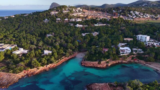 travel in the Balearics, coast of Ibiza with crystal clear turquoise water, drone shot of Cala Gracio in Ibiza, tourism in Balearic Islands, vacation in Ibiza