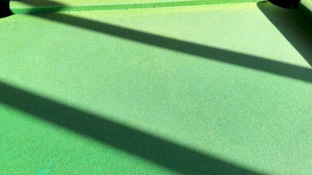 Slow Motion Yellow Billiard Ball Rolling Across Green Felt Table