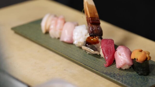 Chef Brushing Soy Sauce on Traditional Japanese Omakase Nigiri Sushi Set