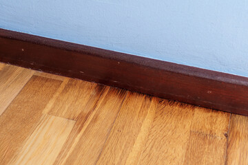 A floor rotting from dampness with black spots on the decaying surface