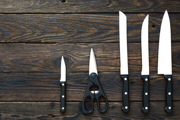 Assorted Kitchen Knives and Scissors on Wooden Surface