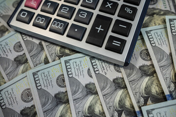 Financial Accounting and Business Planning with Calculator on American Hundred Dollar Banknotes