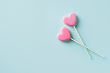 Valentines day concept with two pink heart shape lollypop