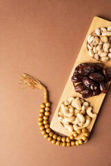 Ramadan kareem background with dates, rosary, cashews and pistachios
