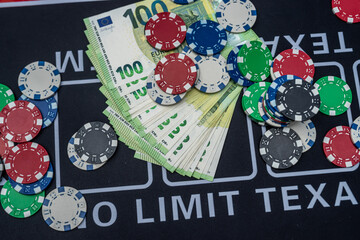 Poker chips and stacks of 100 euro banknotes symbolizing gambling, money and casino winnings