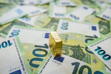 Stack of gold bars on euro banknotes representing wealth, fortune and long term financial growth