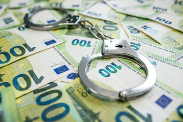Corruption and crime concept with 100 euro notes and handcuffs