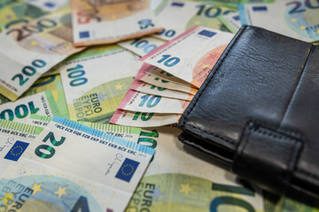 Euro banknotes with wallet background of modern finance