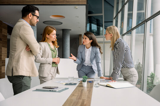 Business team discussing project at table in modern office