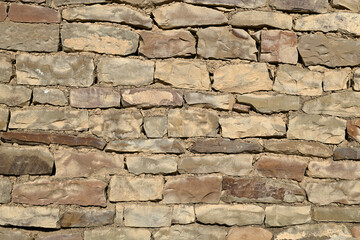 Fototapeta premium Textured vintage-style wall made of decorative mountain stone