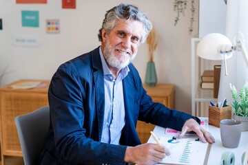 Businessman analyzing strategy at desk in modern office