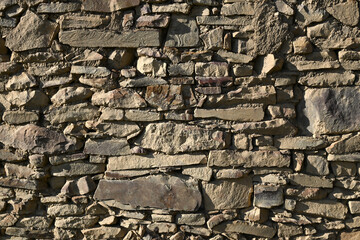 Fototapeta premium Textured vintage-style wall made of decorative mountain stone