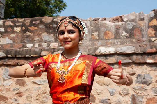 Portrait of a Smiling teenage girl performing the Bharat Natyam traditional Indian dance