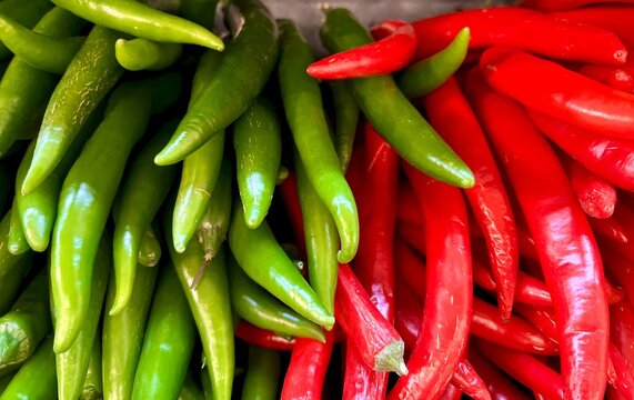 Full frame close-up of a stack of red and green chillies