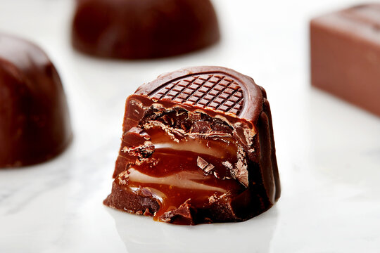 Close-up of a half eaten milk Chocolate Praline with Caramel Filling on a table