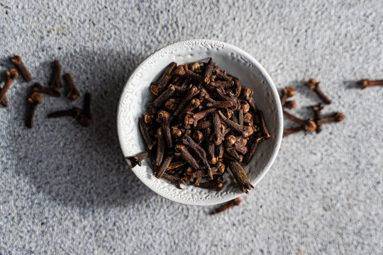 Overhead view of a bowl of fresh cloves on a table
