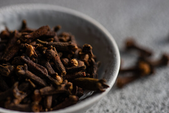 Close-up of a bowl of fresh cloves on a table