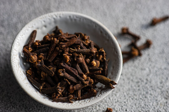 Overhead view of a bowl of fresh cloves on a table