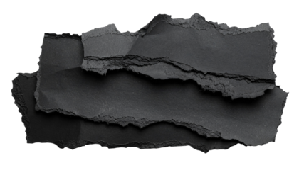 Torn, layered pieces of black paper against a stark black background