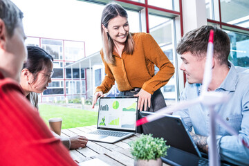 Teamwork meeting in modern office discussing sustainability and wind energy