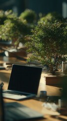 Office desk with a laptop and green plant, creating a harmonious and natural work environment