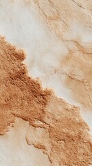 Sand texture showing subtle relief patterns with neutral beige and brown earth tones