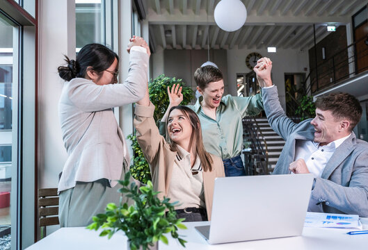 Business team celebrating success together in modern office