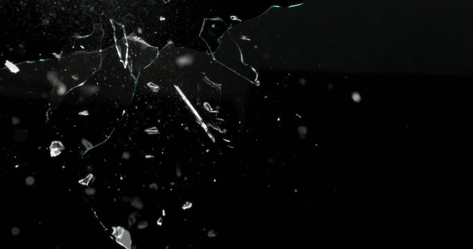 Experience stunning dynamic footage showcasing glass dramatically shattering against a dark backdrop, perfectly suited for a variety of motion graphics and visual effects projects you might undertake