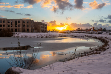 Sun sets on snow in Westergouwe as winter storm system brings unusually heavy snowfall in the Netherlands. Code Orange weather warning is in effect