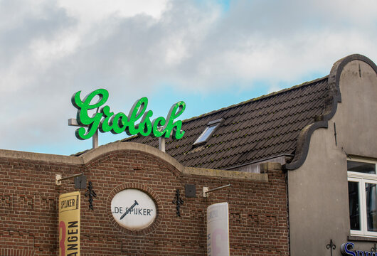 Sign for Grolsch brewery on building in Dutch town with cloudy sky above Grolsch sign on the cafee on a sunny day on a street during the day in a city   - Netherlands. Eindhoven 26-10-2025