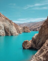 Turquoise lake tucked between rugged brown canyon walls with distant mountains under a clear blue sky. Concept Turquoise lake, Brown canyon walls, Distant mountains, Clear blue sky, Serene landscape