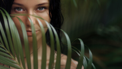 Mystery Jungle Woman Eyes Behind Tropical Palm Leaves Background View