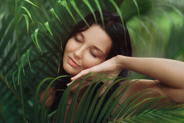 Naklejka premium Serene Woman Enjoying Nature Surrounded by Tropical Greenery
